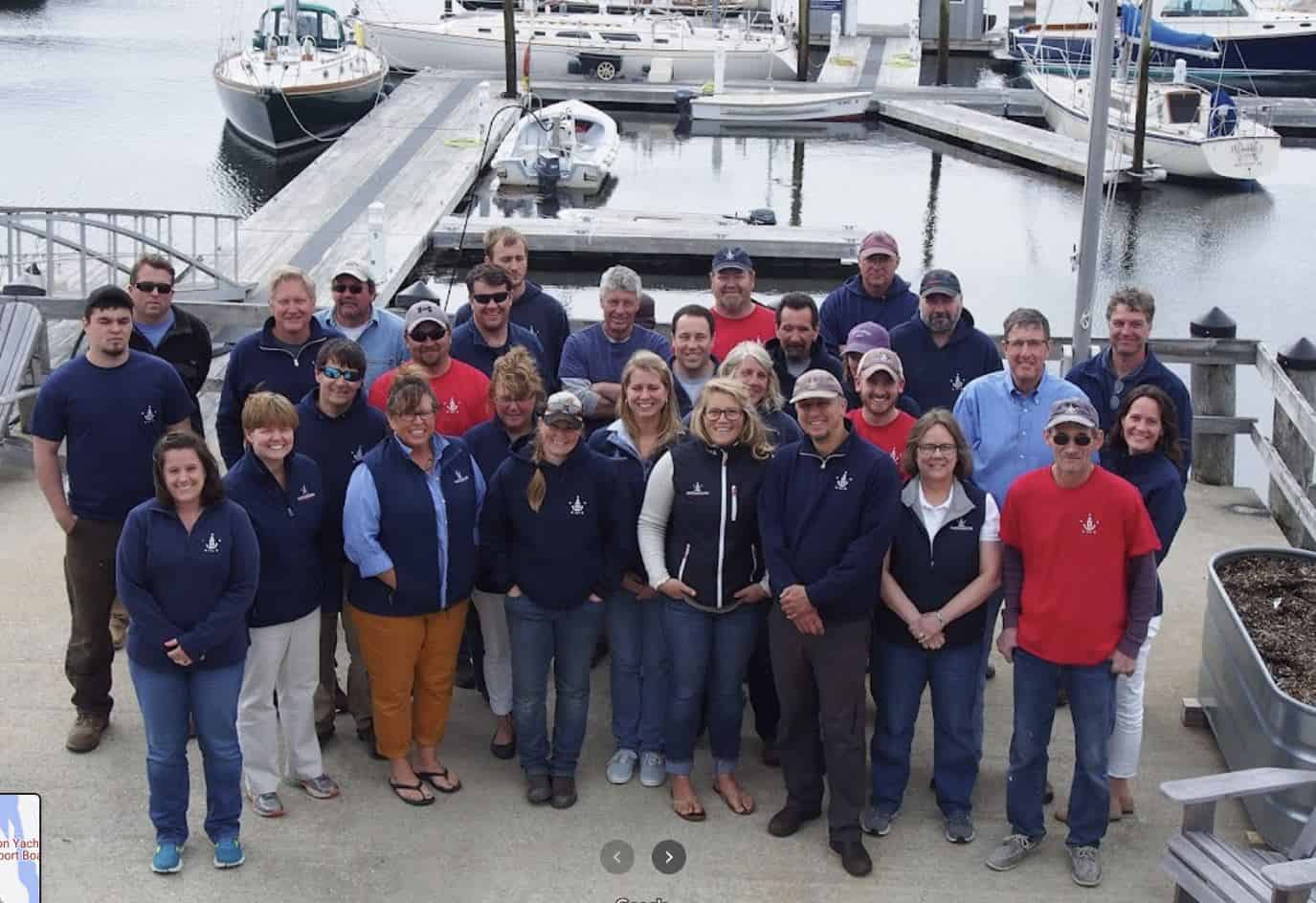 Staff of Hodgdon Yacht Services clustered on a dock.