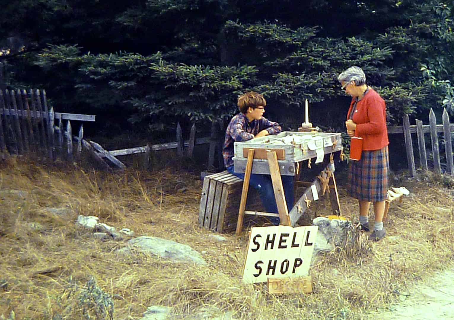 boy selling shells to an older woman