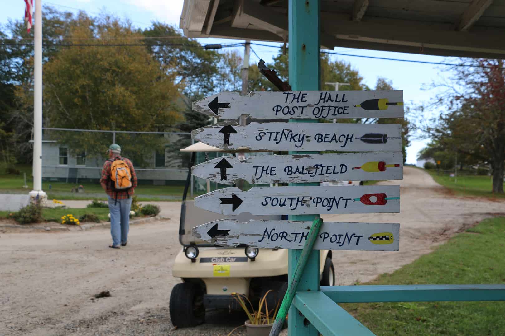 sign boards pointing to various places on the island