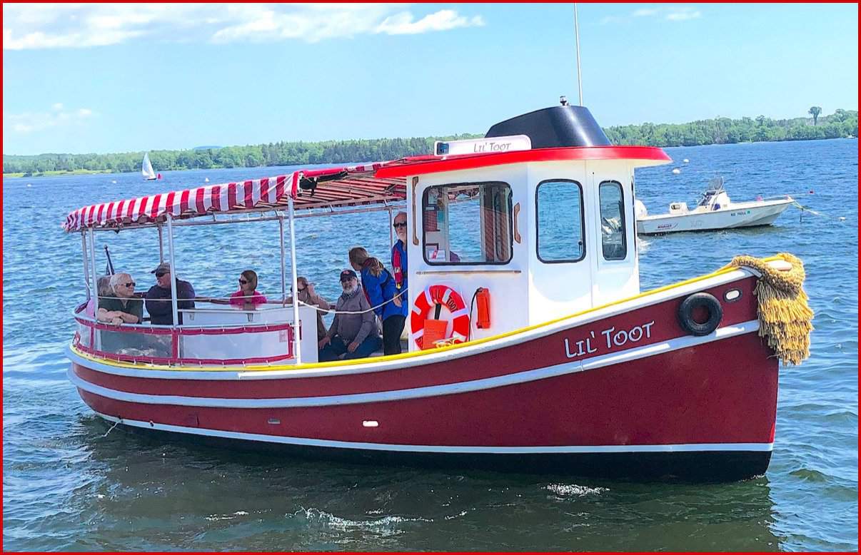 Red and white small tugboat-type tour boat.