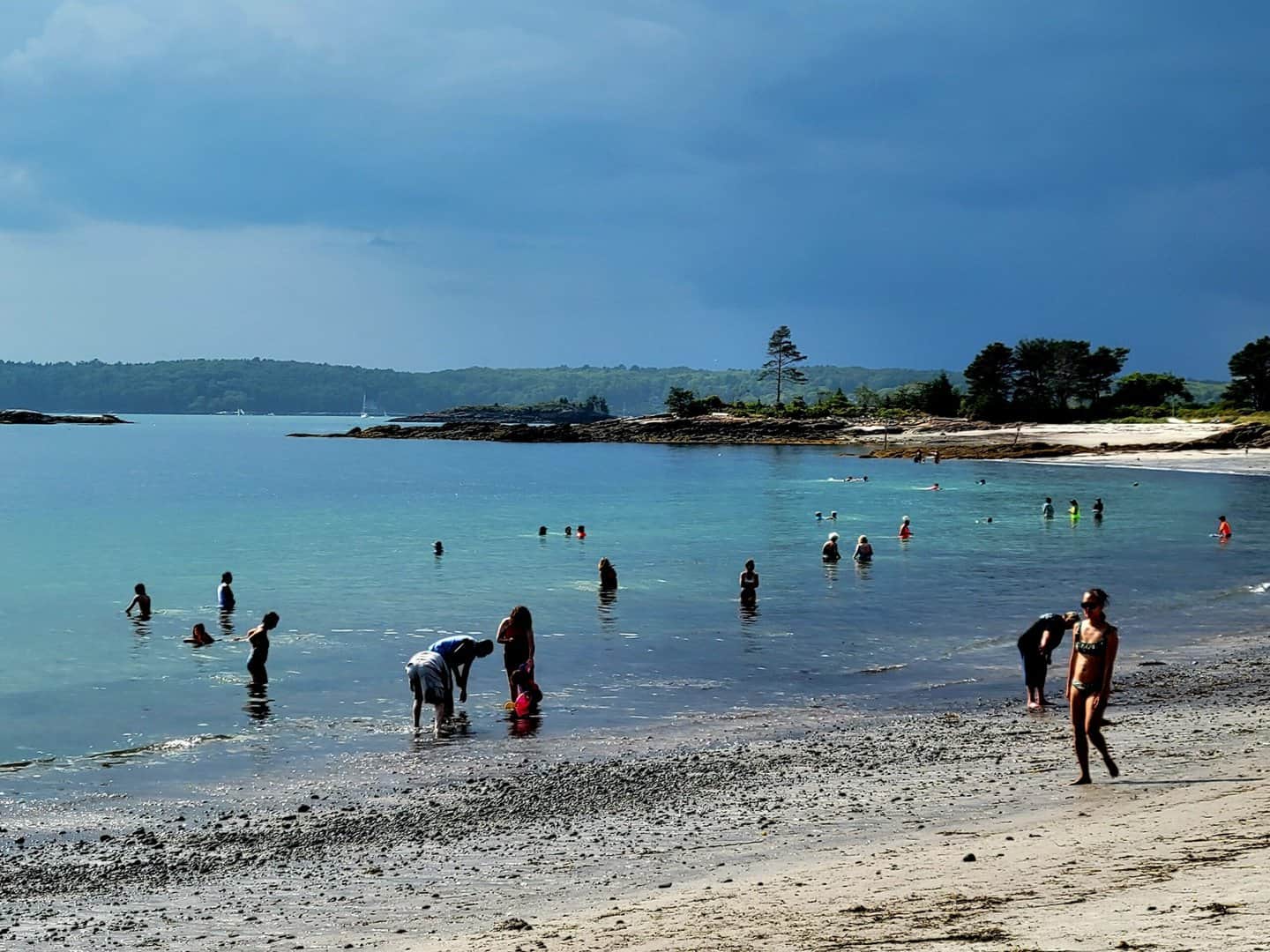 People wading in shallow water at Pemaquid Beach