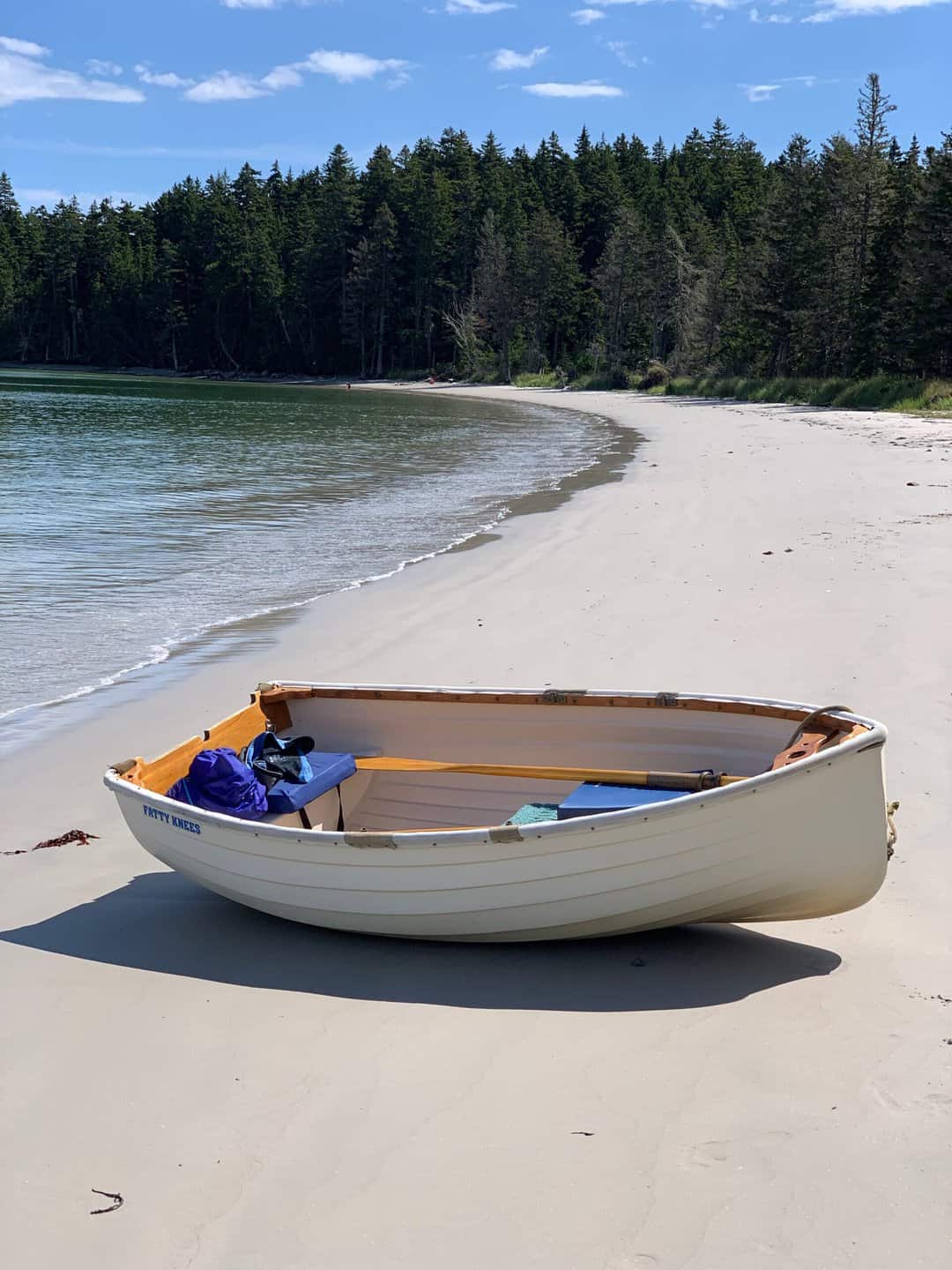 dinghy pulled up on long sandy beach