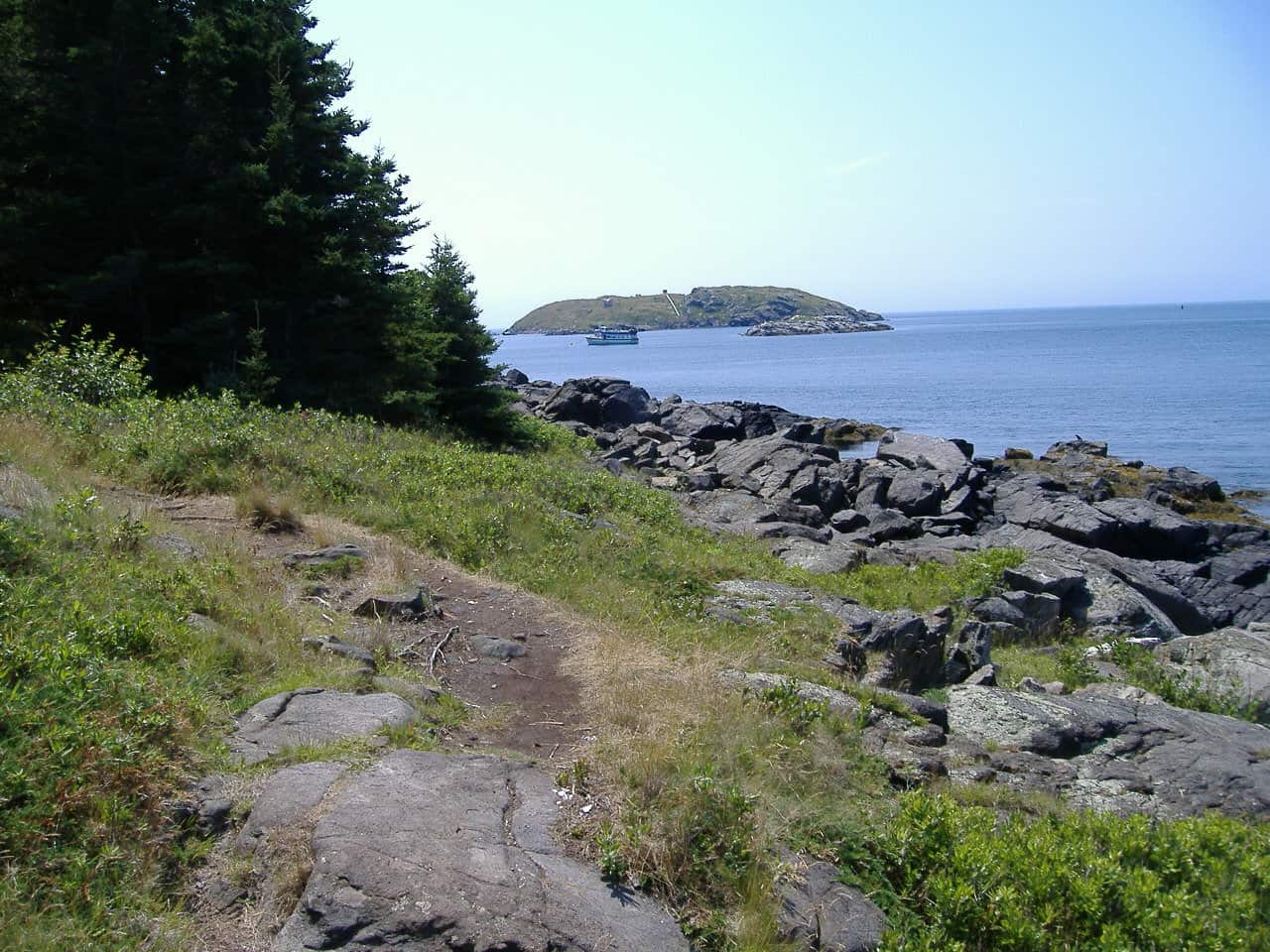 Island trail with rocky shore and another island in the distance.