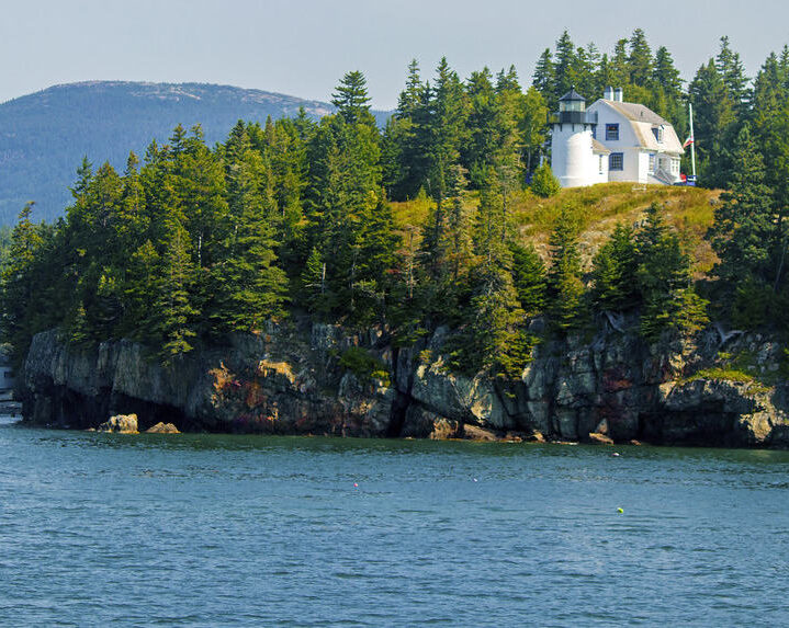 Bear Island with white lighthouse up on a cliff.