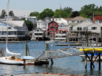 Boothbay waterfront with dock in foreground and buildings across the water.