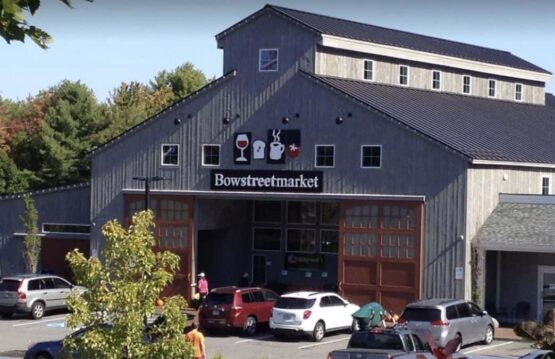 Bow Street Market, a barn-style building with open doors and cars parked in front