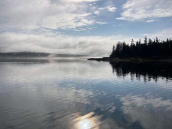 early morning fog beyond islands, calm water