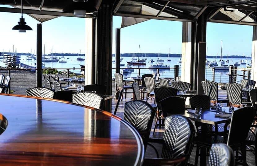 Restaurant interior overlooking moored boats.