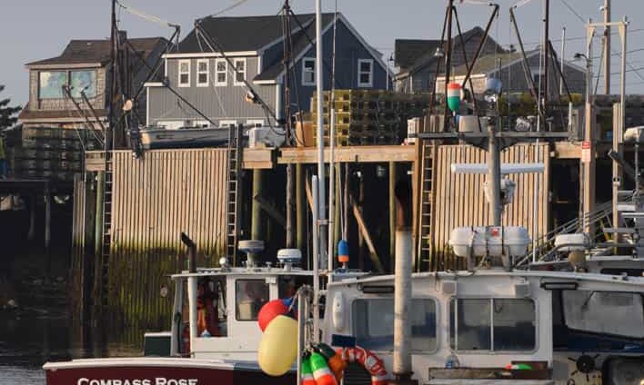 Matinicus Fishing Stages with two fishing boats in the foreground.
