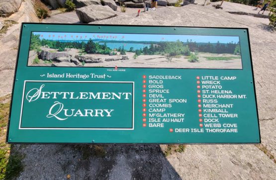 Settlement Quarry sign labeling points of interest in the distance