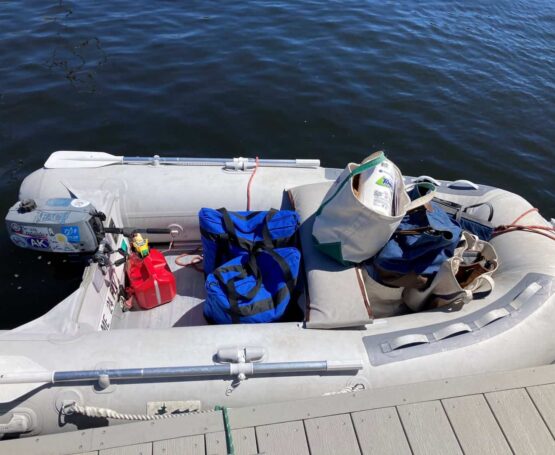 grocery totes loaded into dinghy at dock