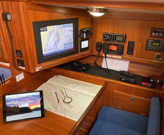 nav table with chart, CCA cruising guide on iPad, computer screen showing chartplotter image